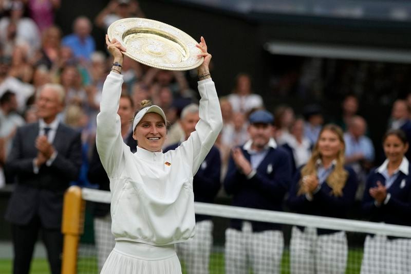 FILE - Czech Republic's Marketa Vondrousova celebrates with the trophy after beating Tunisia's Ons Jabeur in the women's singles final on day thirteen of the Wimbledon tennis championships in London, Saturday, July 15, 2023. This year's Wimbledon tournament begins on Monday, July 1.(AP Photo/Alastair Grant, File)