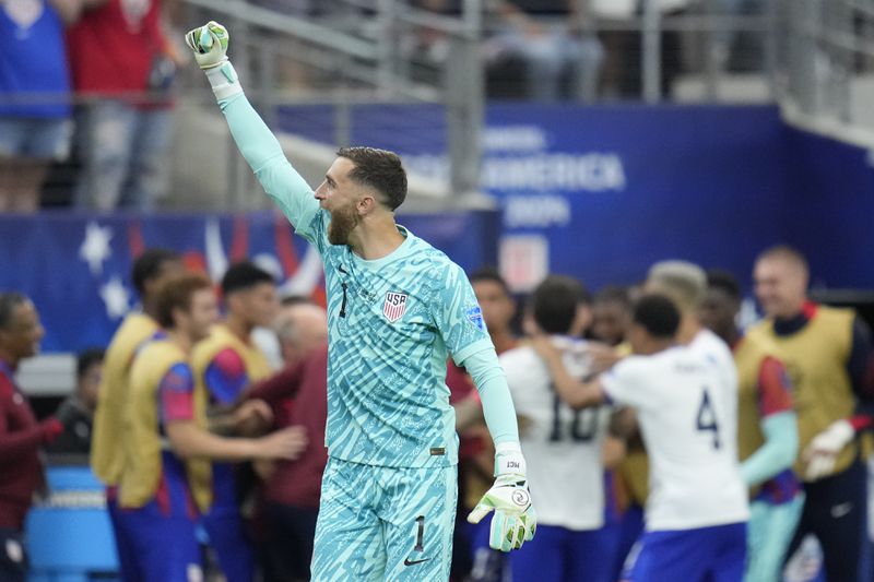 Goalkeeper Matt Turner of the United States celebrates his side's opening goal against Bolivia scored by teammate Christian Pulisic during a Copa America Group C soccer match in Arlington, Texas, Sunday, June 23, 2024. (AP Photo/Julio Cortez)