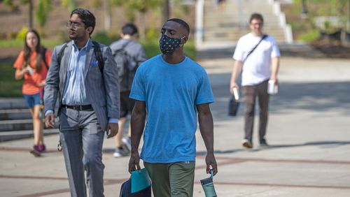 Masked and unmasked individuals walk the campus of Georgia Tech in September. (Alyssa Pointer/Atlanta Journal Constitution)