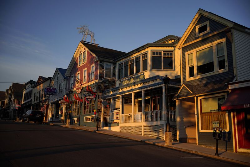 FILE - Early-morning light shines on shops on Main Street, Saturday, June 11, 2022, in Bar Harbor, Maine. (AP Photo/Robert F. Bukaty, File)