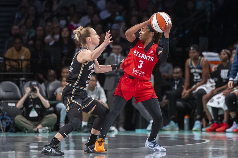 Atlanta Dream guard Jordin Canada (3) is defended by New York Liberty guard Courtney Vandersloot (22) during the first half of a WNBA first round game 1 playoff basketball game, Sunday, Sept. 22, 2024, in New York. (AP Photo/Corey Sipkin)