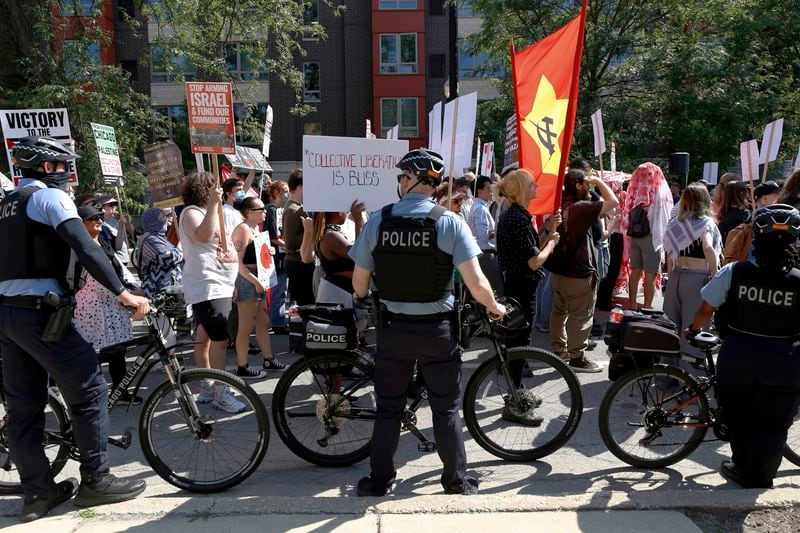 Chicago police use bicycles to make a rolling barrier along the March on DNC on Monday, Aug. 19, 2024, in Chicago. (AP Photo/Martha Irvine)