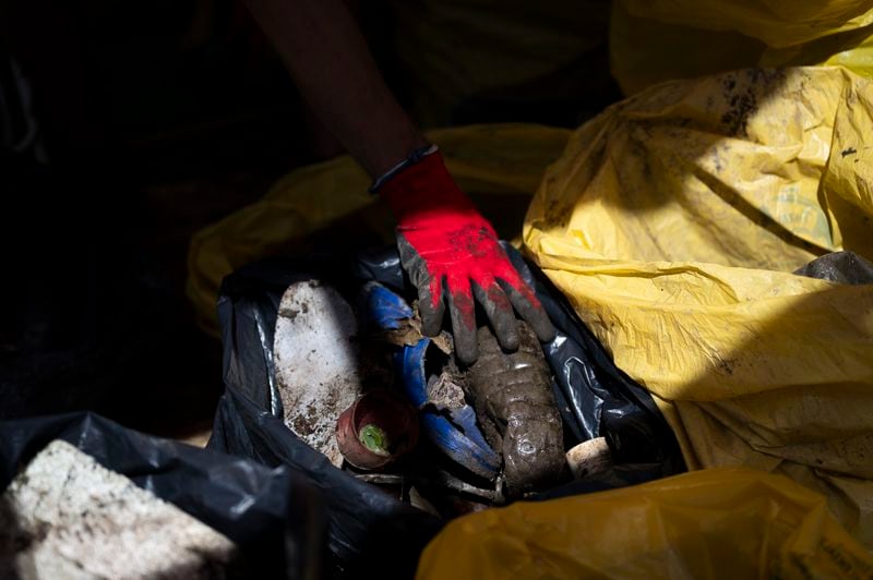 FILE - Volunteers sort the collected rubbish on their boat while attending the Plastic Cup event near Tiszaroff, Hungary, Aug. 2, 2023. (AP Photo/Denes Erdos)