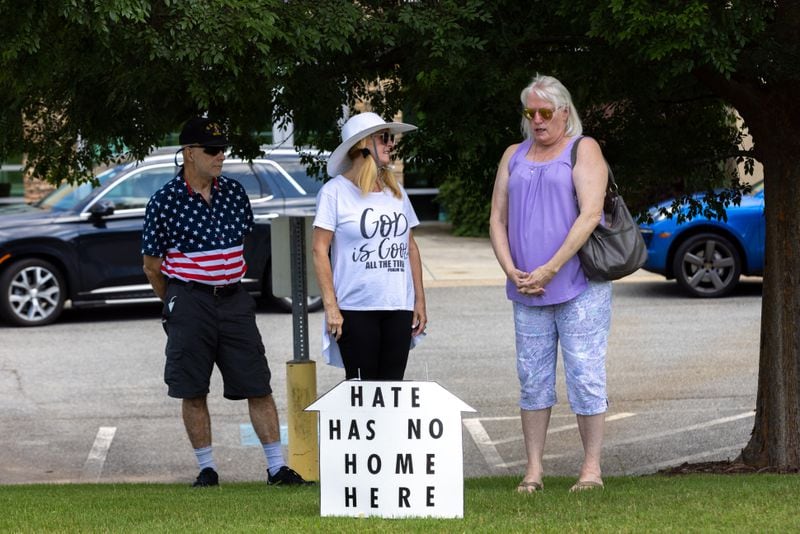 Larry Holt, Christine Holt, and Nancy Beres stand in front of Chabad of Cobb in Marietta on Monday before learning a rally had been postponed. Supporters of the synagogue planned to rally in solidarity after a group of neo-Nazis demonstrated in front of the synagogue over the weekend. (Arvin Temkar / arvin.temkar@ajc.com)