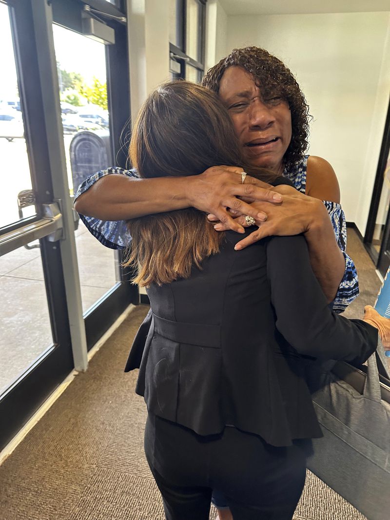 FILE - Augustina Sanders hugs Kim Ludwig, a paralegal in the Federal Public Defender's Office in Oklahoma City, after the Oklahoma Pardon and Parole Board voted 3-2 to recommend clemency for Sanders' brother, Emmanuel Littlejohn, Aug. 7, 2024. (AP Photo/Sean Murphy, File)