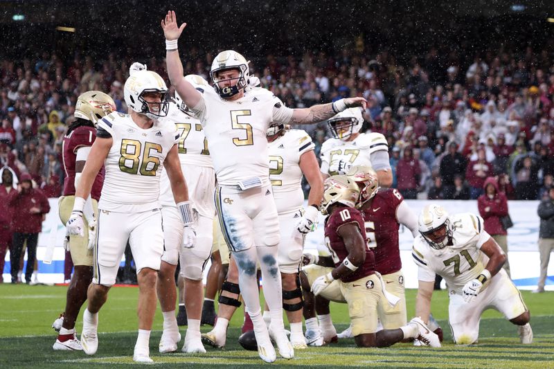 Georgia's Clayton Powell-Lee, center, celebrates a touch down during the NCAA college football game between Georgia Tech and Florida State at the Aviva stadium Dublin, Saturday, Aug. 24, 2024. (AP Photo/Peter Morrison)