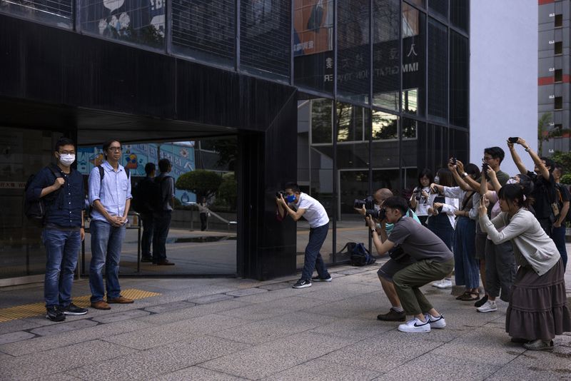 FILE - Chung Pui-kuen, second left, former chief editor and Patrick Lam, left, former acting editor of the now-defunct independent media outlet Stand News leave the court on the last day of the publication's sedition trial closing statements, in Hong Kong, Wednesday, June 28, 2023. (AP Photo/Louise Delmotte, File)