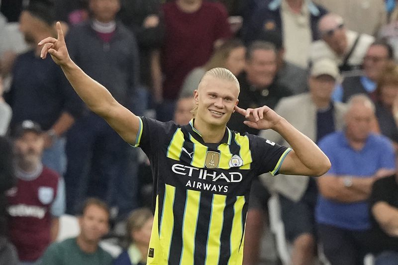 Manchester City's Erling Haaland celebrates after scoring his side's second goal during the English Premier League soccer match between West Ham United and Manchester City at the London Stadium in London, England, Saturday, Aug. 31, 2024. (AP Photo/Frank Augstein)