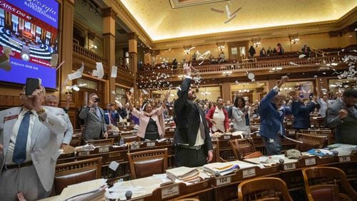 House members throw up paper at the conclusion of the legislative session in the House Chamber on Sine Die, the last day of the General Assembly at the Georgia State Capitol in Atlanta on Tuesday, April 5, 2022.   Branden Camp/ For The Atlanta Journal-Constitution