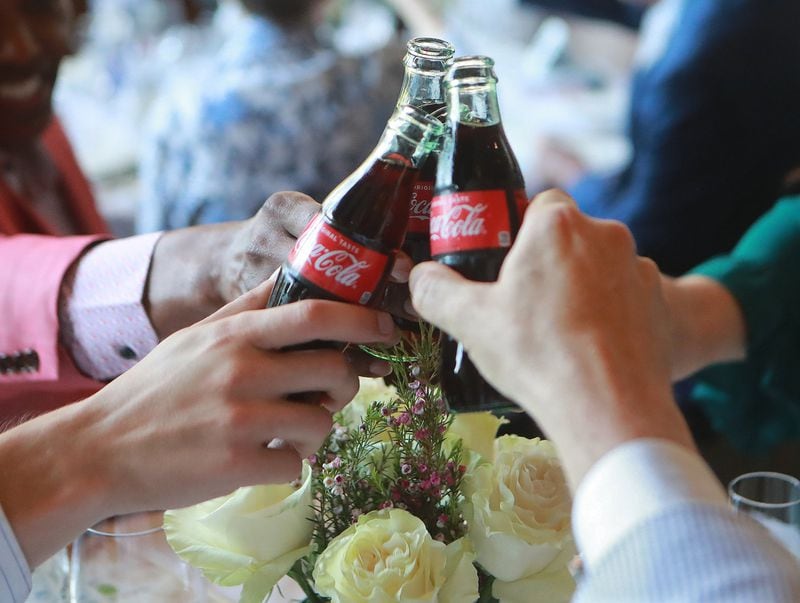 Guests at the preview dinner for the Georgia Grown event begin their meal with a toast with bottled Coca-Cola. The famous Atlanta product would also be a part of the New York City meal. CURTIS COMPTON / CCOMPTON@AJC.COM