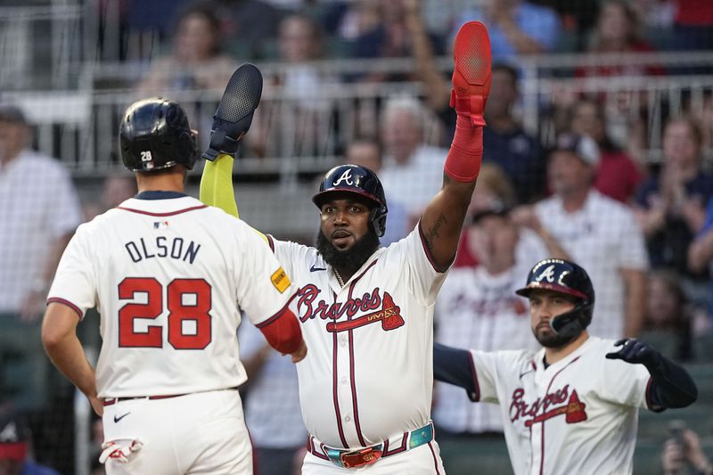 Atlanta Braves' Marcell Ozuna (20) and Matt Olson (28) celebrate scoring after a double RBI hit by Atlanta Braves' Austin Riley (27) in the fifth inning of a baseball game against the Wednesday, July 3, 2024, in Atlanta. (AP Photo/Brynn Anderson)