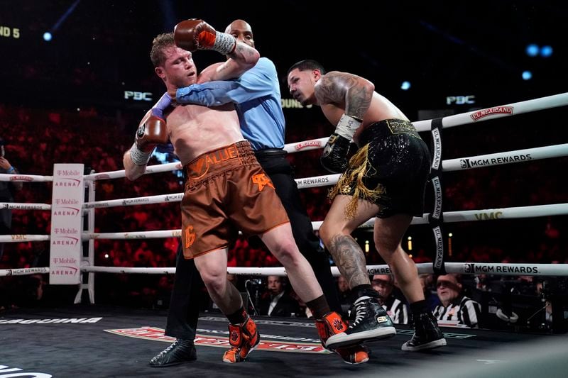 Referee Harvey Dock pulls Canelo Alvarez and Edgar Berlanga apart in their super middleweight title bout Saturday, Sept. 14, 2024, in Las Vegas. (AP Photo/John Locher)