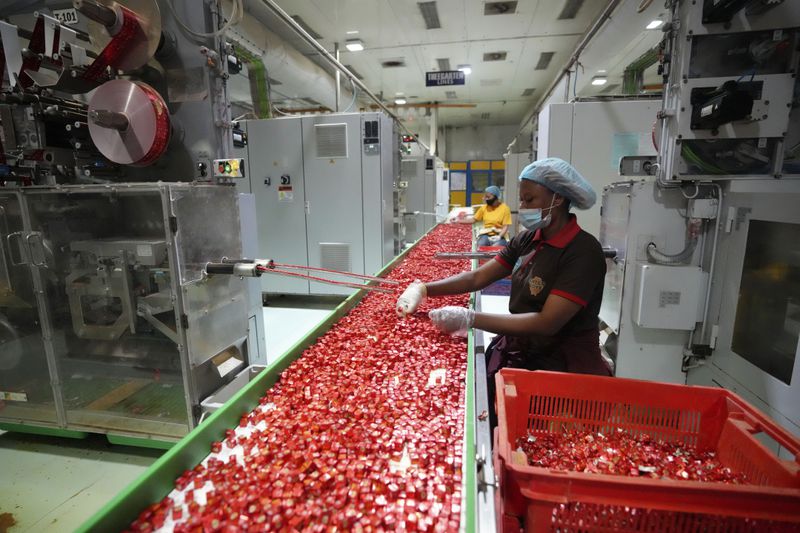 Workers package bouillon cubes at the Sweet Nutrition factory in Ota, Nigeria, Thursday, Sept. 12, 2024. (AP Photo/Sunday Alamba)