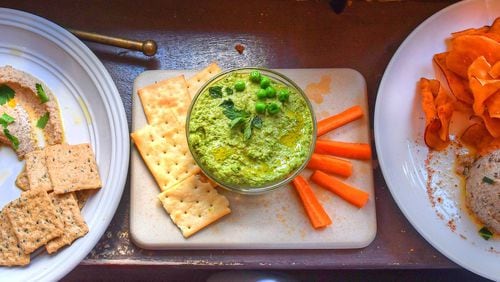 Add some flair to those meals at home with Black Chickpea Hummus with Black Garlic and Preserved Lemon (from left), Sweet Pea and Sun Butter Hummus, and Wisteria’s Black-Eyed Pea Hummus. STYLING BY SUSAN PUCKETT AND JASON HILL / CONTRIBUTED BY CHRIS HUNT PHOTOGRAPHY