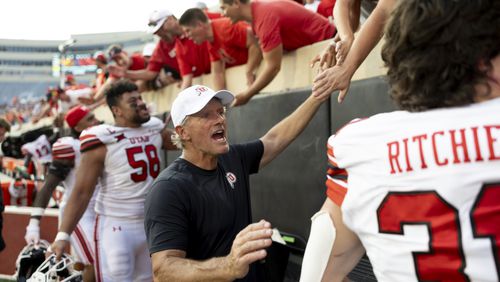 Utah head coach Kyle Whittingham celebrates with players and fans after an NCAA college football game against Oklahoma State, Saturday, Sept. 21, 2024, in Stillwater, Okla. (AP Photo/Mitch Alcala)