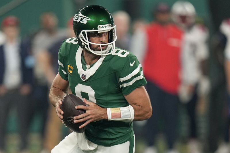 New York Jets quarterback Aaron Rodgers (8) steps back to pass against the New England Patriots during the first quarter of an NFL football game, Thursday, Sept. 19, 2024, in East Rutherford, N.J. (AP Photo/Seth Wenig)