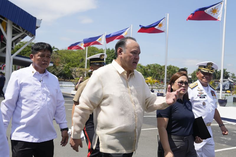 Philippine Defense Secretary Gilberto Teodoro, center, walks with his staff after attending the 126th Philippine Navy anniversary in Manila, Philippines on Friday, May 24, 2024. The Philippines would press efforts to build security alliances and stage realistic combat drills, including joint naval sails with the United States, Japan and Australia in disputed waters, to defend its territorial interests, Defense Secretary Gilberto Teodoro said Friday, dismissing China's criticisms of such moves as a sign of paranoia. (AP Photo/Aaron Favila)
