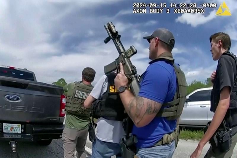 In this image taken from police body camera video and released by the Martin County, Fla., Sheriff’s Office, law enforcement officers prepare to arrest Ryan Routh, the man suspected in the apparent assassination attempt of Donald Trump, Sunday, Sept. 15, 2024. (Martin County Sheriff’s Office via AP)