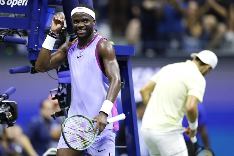 Frances Tiafoe, of the United States, pumps his fist after winning a game against Grigor Dimitrov, of Bulgaria, right, during the quarterfinals of the U.S. Open tennis championships, Tuesday, Sept. 3, 2024, in New York. (AP Photo/Adam Hunger)