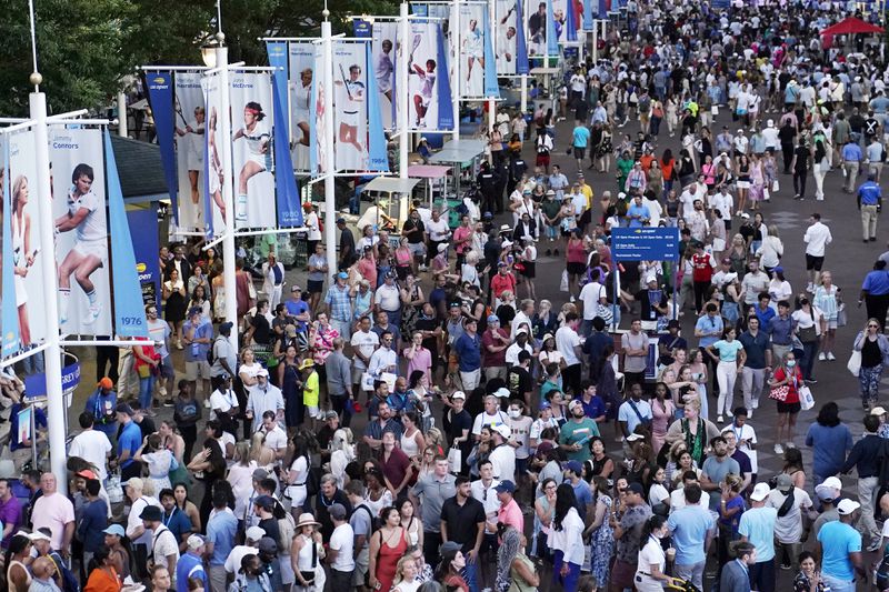 FILE - Tennis fans walk the grounds of the Billie Jean King National Tennis Center during the second round of the U.S. Open tennis championships, Wednesday, Aug. 31, 2022, in New York. The 2024 U.S. Open begins Monday, Aug. 26.(AP Photo/Julia Nikhinson, File)