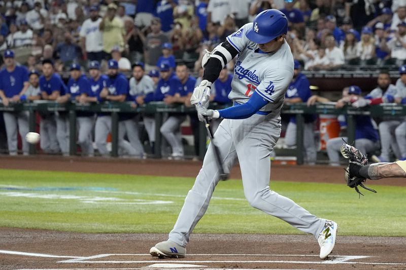 Los Angeles Dodgers designated hitter Shohei Ohtani, of Japan, connects for a double against the Arizona Diamondbacks during the first inning of a baseball game Friday, Aug. 30, 2024, in Phoenix. (AP Photo/Ross D. Franklin)