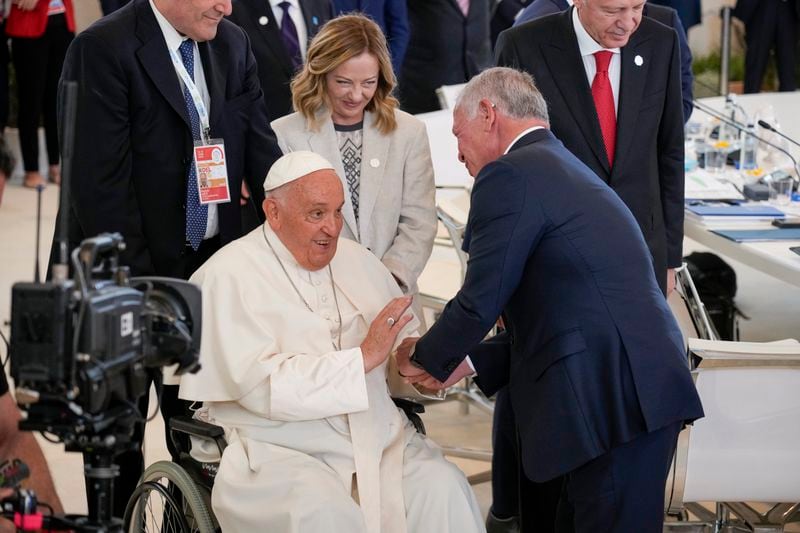 Pope Francis, left, greets Jordan's King Abdullah II during a working session on AI, Energy, Africa and Mideast at the G7 summit, in Borgo Egnazia, near Bari in southern Italy, Friday, June 14, 2024. (AP Photo/Andrew Medichini)