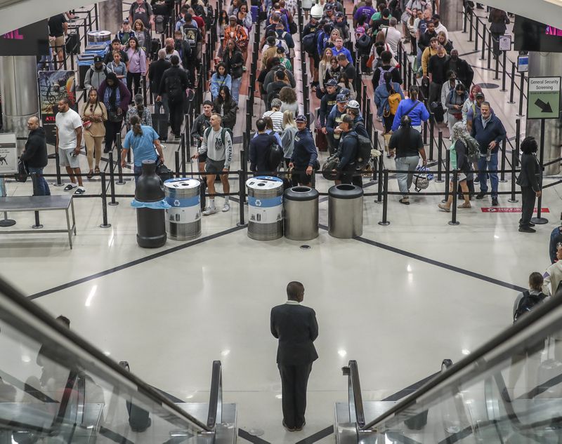May 25, 2023 Hartsfield-Jackson International Airport: Here travelers surge at the main security checkpoint inside the airport Thursday morning, May 25, 2023 where Large crowds are expected to pass through Hartsfield-Jackson International Airport throughout the Memorial Day weekend. (John Spink / John.Spink@ajc.com)

