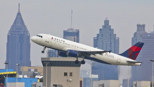 With gray skies over the Atlanta skyline a Delta jet takes off on Tuesday, Oct. 30, 2012. JOHN SPINK / JSPINK@AJC.COM