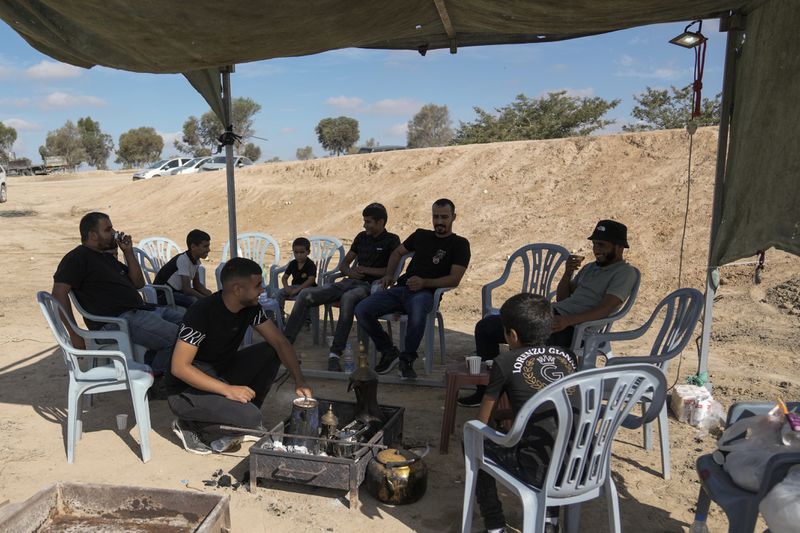 Relatives and friends of Qaid Farhan Alkadi, 52, who was held hostage by Hamas militants in Gaza Strip, wait for his arrival on an area in the Khirbet Karkur village, near Rahat, southern Israel, Wednesday, Aug. 28, 2024. (AP Photo/Mahmoud Illean)