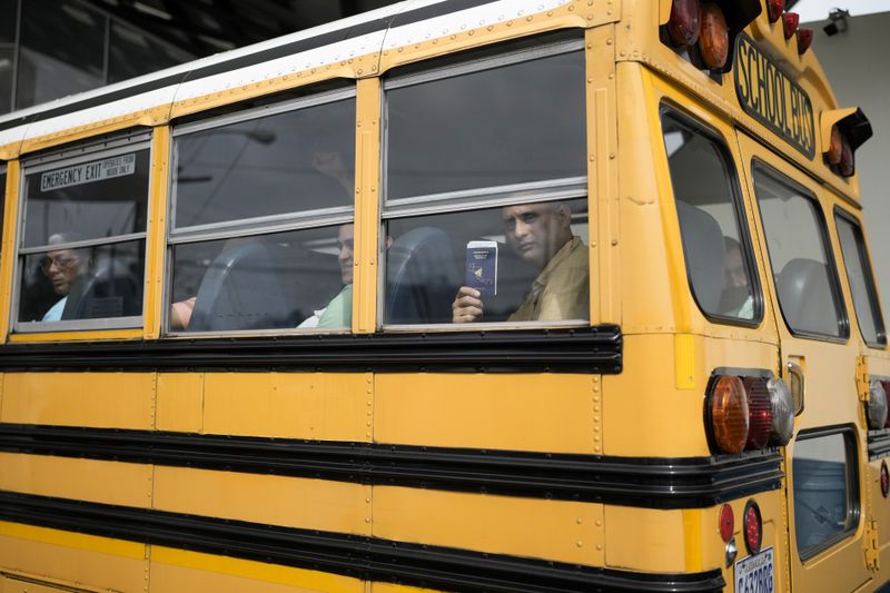 A Nicaraguan citizen shows his passport from a bus after being released from a Nicaraguan jail and landing at the airport in Guatemala City, Thursday, Sept. 5, 2024. (AP Photo/Moises Castillo)