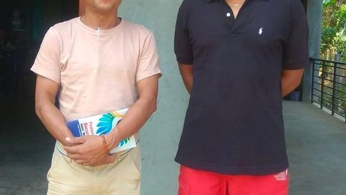 Aung San Oo, left, and Myo Myint Oo, pose for a picture in front of the office of the Tanintharyi Weekly Journal published by Dawei Watch media, in Dawei township in Tanintharyi region, Myanmar, in 2020. A military court in Myanmar has given a life prison sentence to a local journalist and sentenced one of his colleagues to 20 years after convicting them under a counterterrorism law, their editor said Wednesday. (Zaw Zaw (Myeik) via AP)