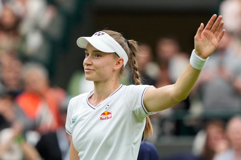 Elena Rybakina of Kazakhstan waves after defeating Elena-Gabriela Ruse of Romania in their first round match at the Wimbledon tennis championships in London, Tuesday, July 2, 2024. (AP Photo/Mosa'ab Elshamy)