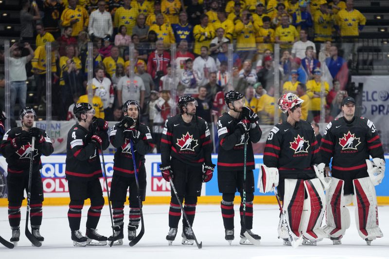 Players of Canada stand on ice after the bronze medal match between Sweden and Canada at the Ice Hockey World Championships in Prague, Czech Republic, Sunday, May 26, 2024. (AP Photo/Petr David Josek)