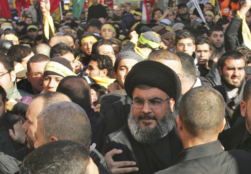 FILE - Hezbollah leader Hassan Nasrallah, center, walks among crowds of supporters during a commemoration in Beirut's southern suburbs, Saturday, on Jan. 19, 2008. (AP Photo/Hussein Malla, File)