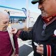 Bill Stephens places a sticker on the vest of his 95-year-old mother, Arline Stephens, after both cast their votes in Gwinnett County during the first day of early voting in the Georgia presidential primary in February. Miguel Martinez/AJC