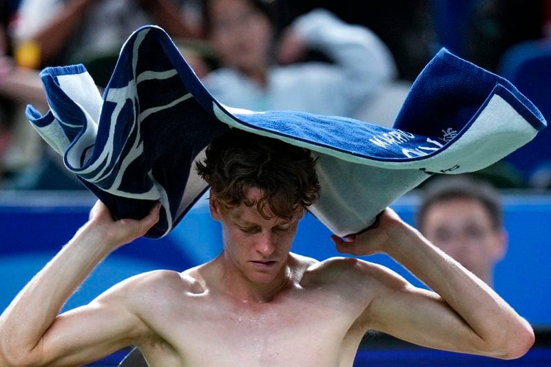 Jannik Sinner of Italy wipes his sweat during a set break in the men's singles match against Tomas Martin Etcheverry of Argentina in the Shanghai Masters tennis tournament at Qizhong Forest Sports City Tennis Center in Shanghai, China, Sunday, Oct. 6, 2024. (AP Photo/Andy Wong)