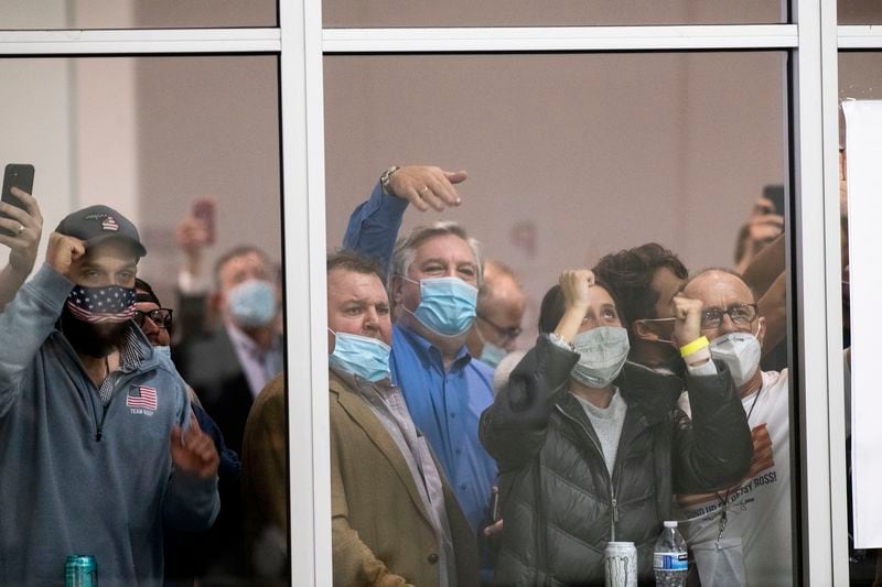 FILE - Election challengers gather outside the TCF Center in Detroit, where absentee ballots were being counted, Nov. 4, 2020. (Nicole Hester/Ann Arbor News via AP, File)