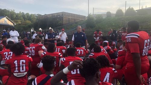 Sandy Creek coach Brett Garvin speaks to his team after the 38-27 win over Newnan in the 2022 Fayetta-Coweta Kickoff Classic.