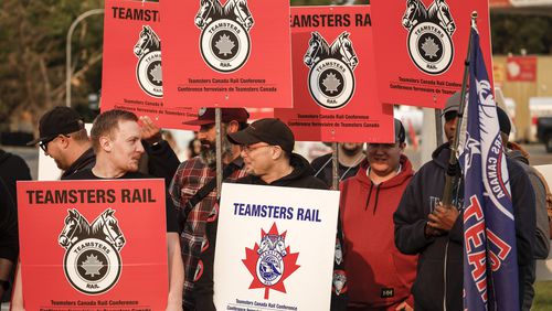 Teamsters Canada Rail Conference members picket outside the CPKC headquarters in Calgary on Friday, Aug. 23. (Jeff McIntosh/The Canadian Press via AP)