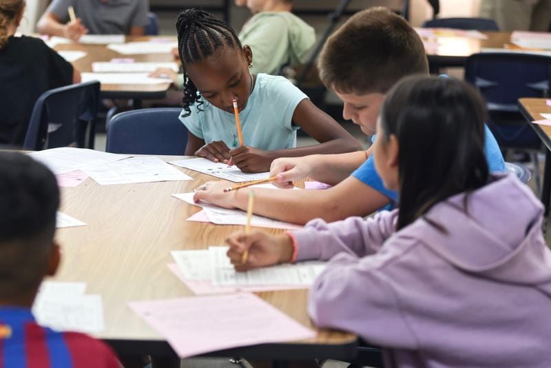 Fifth grade students work on classwork on the first day of school at Harmony Elementary School in Buford on Wednesday, Aug. 2, 2023. (Natrice Miller/ Natrice.miller@ajc.com)