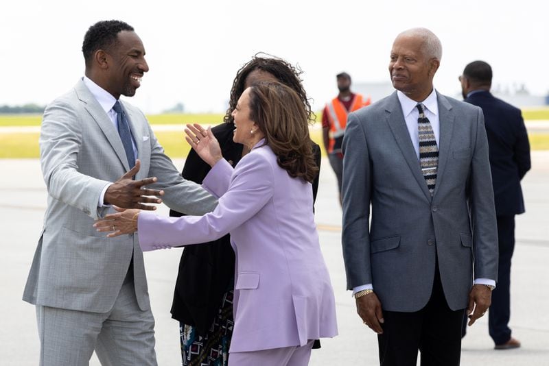 Atlanta Mayor Andre Dickens greets Vice President Kamala Harris as she arrives in Atlanta on Tuesday, June 18, 2024, while U.S. Rep. Hank Johnson, D-Lithonia, (right) looks on. Harris will headline a Juneteenth Block Party after holding a conversation with hip-hop star Quavo at his summit to stop gun violence. (Arvin Temkar / AJC)