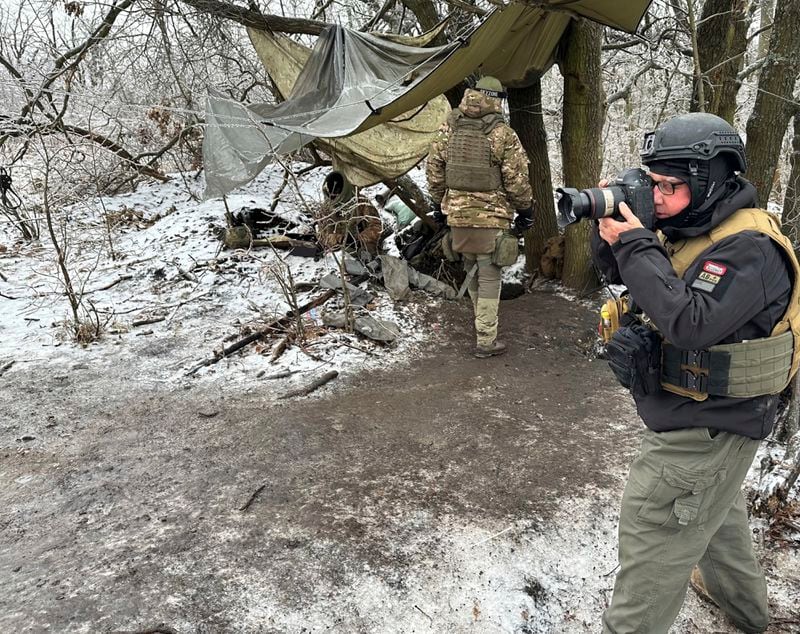 In this undated photo, Philanthropist Howard Buffett, who will help distribute his dad Warren Buffett’s fortune after his death, takes pictures in Donetsk Oblast, Ukraine, during one of his many trips to Ukraine since Russia invaded that country. (Oles Maliarevych via AP)