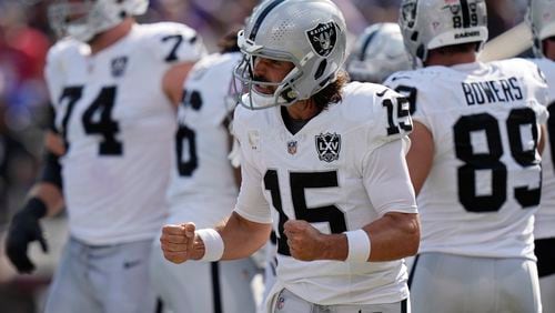 Las Vegas Raiders quarterback Gardner Minshew (15) celebrates after running back Alexander Mattison scored a touchdown against the Baltimore Ravens during the second half of an NFL football game, Sunday, Sept. 15, 2024, in Baltimore. (AP Photo/Stephanie Scarbrough)