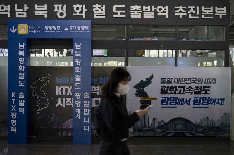 A commuter walks past a banner that reads, "The Future of a Unified Korea, Peace High-Speed Railway, from Gwangmyeong to Pyongyang," at Gwangmyeong station in Gwangmyeong, South Korea, Thursday, May 16, 2024. (AP Photo/Jae C. Hong)