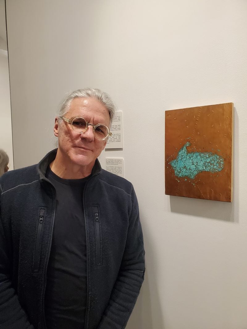 Kenn Kotara standing next to the first panel in his Braille Series, titled re:002.  (Photo Courtesy of Jayla McDaniel/Fresh Take Georgia)