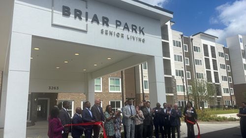 Mayor Andre Dickens and Councilmember Marci Collier Overstreet celebrate with developers in front of Briar Park senior living at Tuesday's ribbon-cutting ceremony.