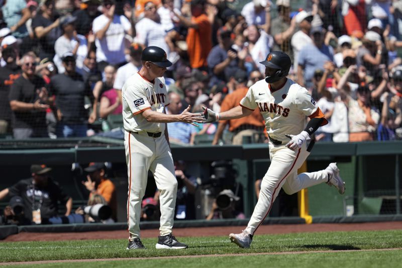 San Francisco Giants' Casey Schmitt, right, celebrates with third base coach Matt Williams after hitting a two-run home run against the Atlanta Braves during the sixth inning of a baseball game Thursday, Aug. 15, 2024, in San Francisco. (AP Photo/Godofredo A. Vásquez)