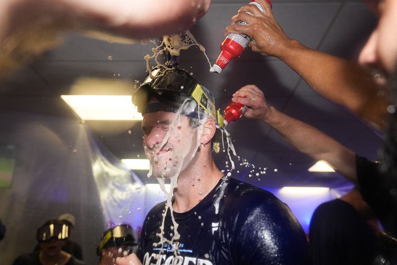 Kansas City Royals pitcher Cole Ragans is doused by teammates celebrating after defeating the Baltimore Orioles 2-1 in Game 2 of an AL Wild Card Series baseball game, Wednesday, Oct. 2, 2024 in Baltimore. (AP Photo/Stephanie Scarbrough)