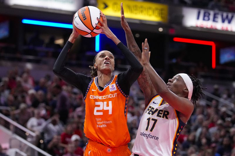 Connecticut Sun forward DeWanna Bonner (24) shoots over Indiana Fever guard Erica Wheeler (17) in the first half of a WNBA basketball game in Indianapolis, Wednesday, Aug. 28, 2024. (AP Photo/Michael Conroy)