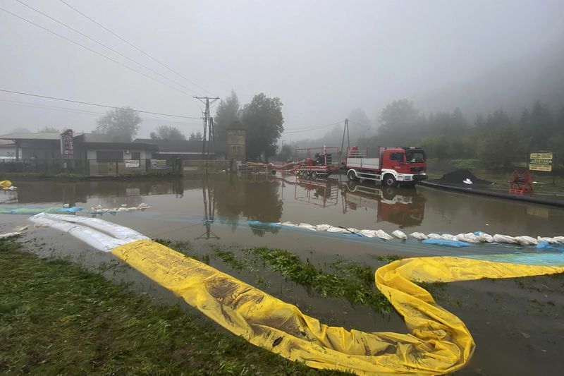 This handout photo provided by the Polish fire department, shows firefighters pump water and mud from city streets and help clean the city of Głogow that was hit by a high flood wave, in Głogow, southwestern Poland, on Wednesday, Sept. 18, 2024. (KG PSP via AP)